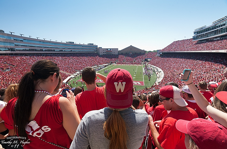 Student Section of Camp Randall Stadium during warm weather and sunny Badger football home game.