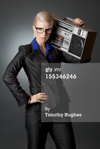 woman in suit with funny boombox in the studio