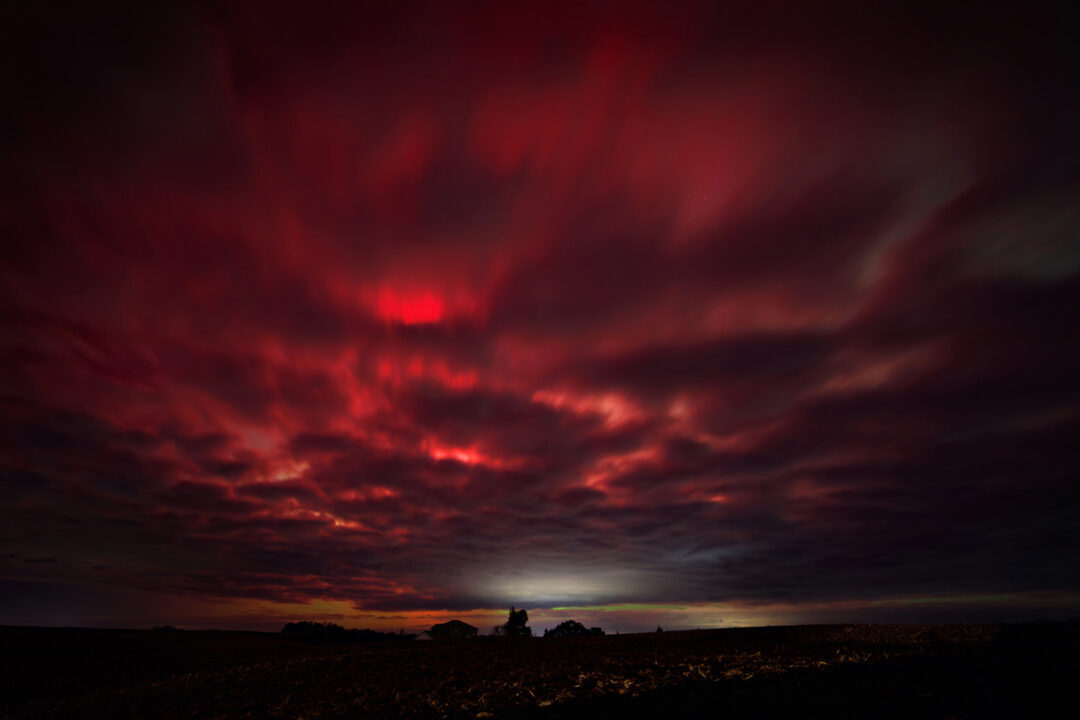 Red cloudy skies during northern lights
