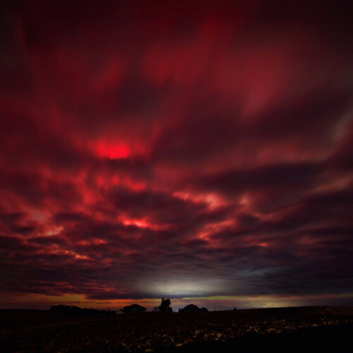 Red cloudy skies during northern lights