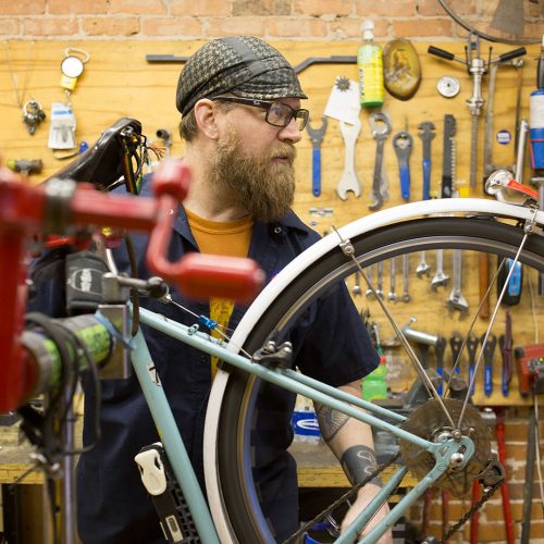 Bike mechanic working in a shop