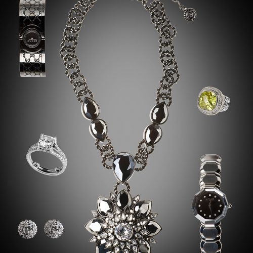 Studio photo of assorted jewelry on gray tabletop