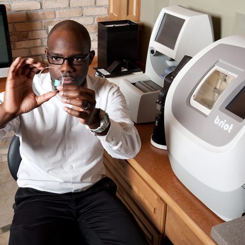 Optician working in an eyewear retail lab